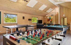 a room with two ping pong tables at Holiday Home Tværvænget Blåvand in Ho +34 photos