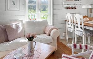 a living room with a couch and a table at 2 Bedroom Gorgeous Home In Hamneda in Annerstad