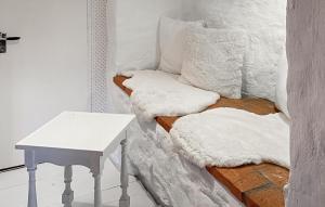 a room with white pillows and a table at 2 Bedroom Gorgeous Home In Hamneda in Annerstad