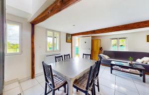 a living room with a table and a couch at 2 Bedroom Lovely Home In Bourville in Sainte-Colombe