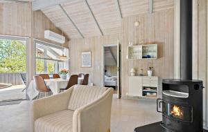 een woonkamer met een bank en een houtkachel bij Amazing Home In Sydals With Wifi in Sønderby