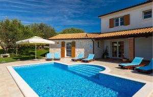 a villa with a swimming pool in front of a house at Villa Loverka in Pula