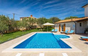 a swimming pool in a yard with a house at Villa Loverka in Pula