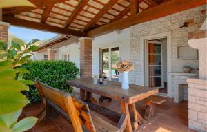 a wooden table and chairs on a patio at Villa Loverka in Pula