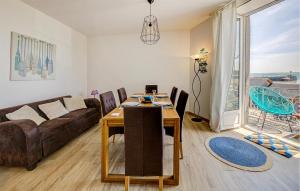 a living room with a couch and a table at Beautiful Apartment In Cancale in Cancale