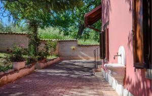 a brick walkway next to a pink building at Nice Home In Bellante With Kitchen in Bellante