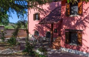a pink house with a table and chairs on a patio at Nice Home In Bellante With Kitchen in Bellante +24 photos