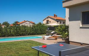 a ping pong table in the backyard of a house at Villa Moraceae in Pula