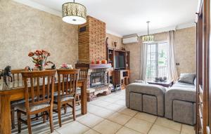 a living room with a couch and a dining room at Beautiful Apartment In Nerja With Wifi in Nerja