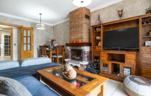 a living room with a blue couch and a fireplace at Beautiful Apartment In Nerja With Wifi in Nerja