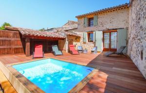 a house with a swimming pool on a wooden deck at Awesome Home In Malataverne With Private Swimming Pool, Can Be Inside Or Outside in Malataverne