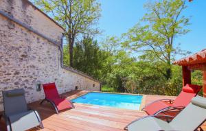 a deck with chairs and a swimming pool at Lovely Home In Malataverne in Malataverne +17 photos