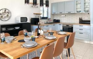 a kitchen with a wooden table and chairs in a kitchen at Villa Morosini in Rovinj