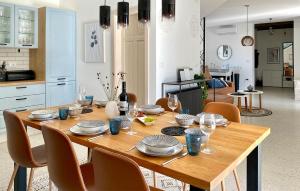 a wooden table with plates and glasses on it in a kitchen at Villa Morosini in Rovinj