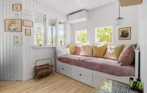 a room with a couch with pillows and windows at Gorgeous Home In Glesborg With Wifi in Glesborg