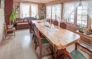 a dining room with a wooden table and chairs at 5 Bedroom Gorgeous Home In Engerdal in Nymoen