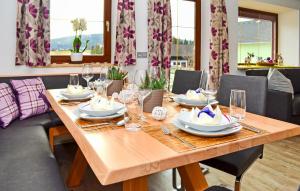 a wooden table with plates and glasses on it at Chalet In Mariapfarr in Mariapfarr