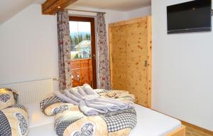 a bedroom with two beds and a window at Chalet In Mariapfarr in Mariapfarr