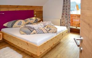 a bedroom with a wooden bed with pillows on it at Chalet In Mariapfarr in Mariapfarr