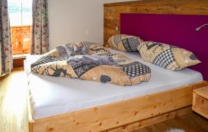 a bed with four pillows on top of it at Chalet In Mariapfarr in Mariapfarr +15 photos