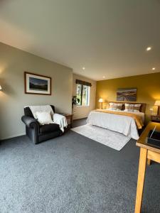 a large bedroom with a bed and a couch at Manakau Lodge in Kaikoura