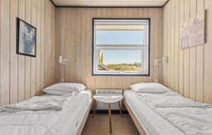 Kærsgård StrandにあるGorgeous Home In Hjrring With Saunaの窓付きの部屋 ベッド2台