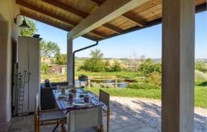 - une table sur une terrasse avec vue sur un champ dans l'établissement Gorgeous Home In Terre Roveresche With Wifi, à San Giorgio di Pesaro