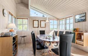 a dining room with a table and chairs at Four-Bedroom Holiday Home In Orsted in Ørsted