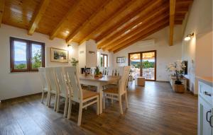 a kitchen and dining room with a table and chairs at Villa Dajana in Potpićan