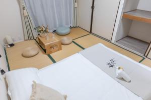 um quarto com uma cama branca e um espelho em 桜の川6 Asakusa 704 Skytree bus 1 min,free wifi,cook,24 hours convenience em Tóquio