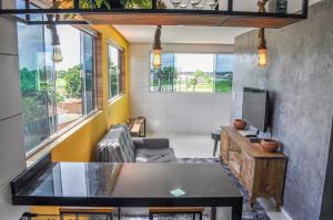 a living room with a table and a tv at Cantinho do Tigela in Bananeiras +12 photos