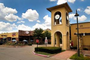 a building with a clock tower on a street at Cozy Modern Retreat, Comfortable and Spacious in Glenn Heights
