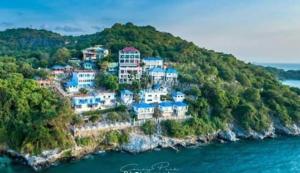 a group of houses on an island in the water at Ocean View Resort - Koh Sichang in Ko Si Chang