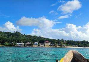 a group of houses on the shore of a beach at KIA HOMESTAY in Banggai