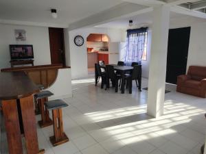 a living room and dining room with a table and chairs at Ender's house in San Andrés
