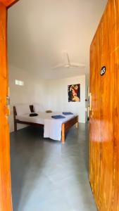 a bedroom with a bed in a room at Ocean Vibe Srilanka in Arugam Bay