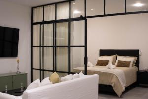 a bedroom with a large bed and a couch at Vizion Juncal- Encanto francés en el corazón de Recoleta- Wifi alta velocidad-Seguridad 24 horas in Buenos Aires