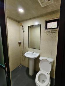 a small bathroom with a toilet and a sink at FortuneBay Hotel in Tabuelan +18 photos