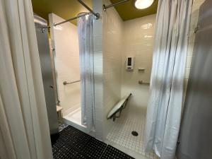 a bathroom with a shower with a shower curtain at Buffalo’s River Den in Buffalo
