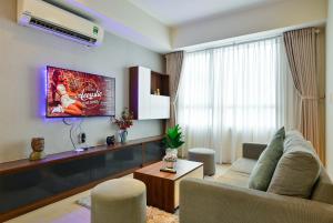 a living room with a couch and a tv at Wonderful 2 BR condo in Masteri T1, fully furnished with full amenities in Ho Chi Minh City
