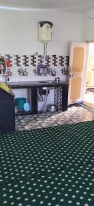 a kitchen with a sink and a counter top at POP Masrat Homestay 