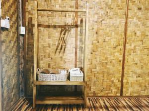 a room with two baskets on a table with a wall at Pai Country Hut in Pai