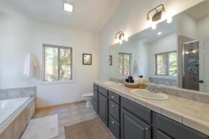 a bathroom with two sinks and a bathtub and a tub at Spacious 4BR Home 2 Decks with BBQ and Outdoor Furniture Walk to Lake Trails and More in Tahoma