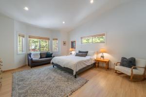 a bedroom with a bed and a couch and a chair at Spacious 4BR Home 2 Decks with BBQ and Outdoor Furniture Walk to Lake Trails and More in Tahoma