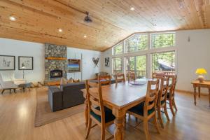 a dining room and living room with a table and chairs at Spacious 4BR Home 2 Decks with BBQ and Outdoor Furniture Walk to Lake Trails and More in Tahoma