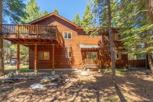 a log cabin in the woods with a deck at Spacious 4BR Home 2 Decks with BBQ and Outdoor Furniture Walk to Lake Trails and More in Tahoma