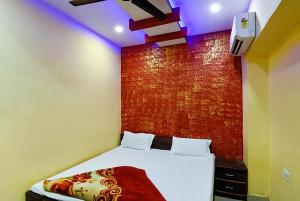una camera con un letto con una parete rossa di Hotel Atithi Galaxy Kanpur Near Railway Station Kanpur - Wonderfull Stay with Family a Kānpur