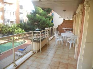 a balcony with a table and chairs and a pool at Apartamentos Palas Salou in Salou