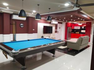 a billiard room with a pool table and a chair at Luxurious Penthouse La Grande Résidence with Home Theater & Netflix in Angeles