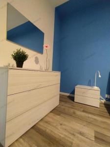 a room with a dresser and a blue wall at Casa Cristina “a Ragusa” in Ragusa